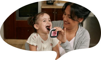 woman examines her child with tytocare device